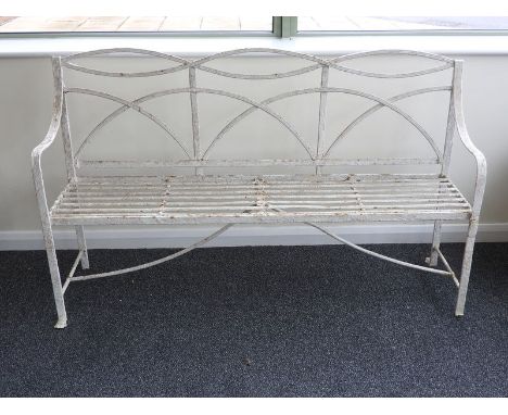 A Regency painted wrought iron garden bench, with shaped openwork back and slat seat grooved arms and paw front feet, 160 wid