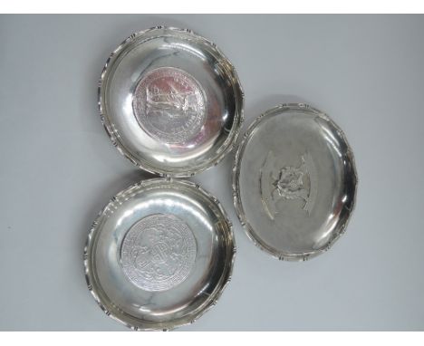 Three Chinese silver trinket dishes, two bearing British Trade dollar coins to base and other bearing Scotch thistle with dat