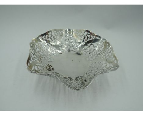 A 1930's silver trinket dish having shaped and pierced decoration and trefoil bun feet, Birmingham 1931, William Adams Ltd,  