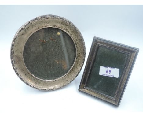 An HM silver photograph frame of circular form having moulded rim and green leather easel stand, marks worn, and a small HM s