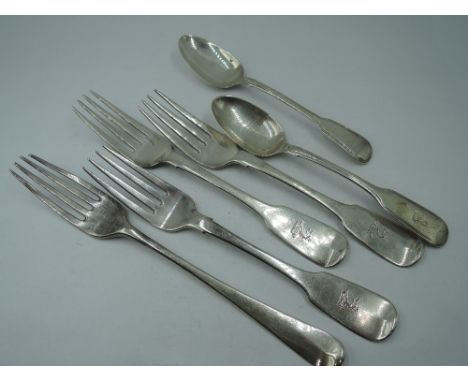 Three Irish Georgian silver dessert forks of fiddle back pattern bearing crest to terminals, Dublin 1827, J Brady, another Ge
