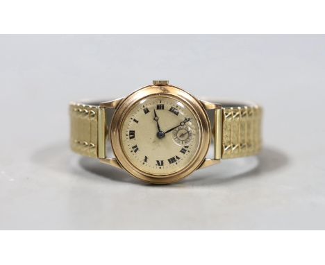 A gentleman's mid 20th century 9ct gold manual wind wrist watch, with Roman dial and subsidiary seconds, on associated flexib