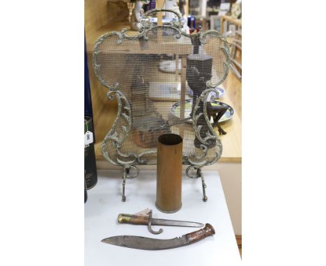 A Louis XV-style fireguard, kukri and bayonet shell case