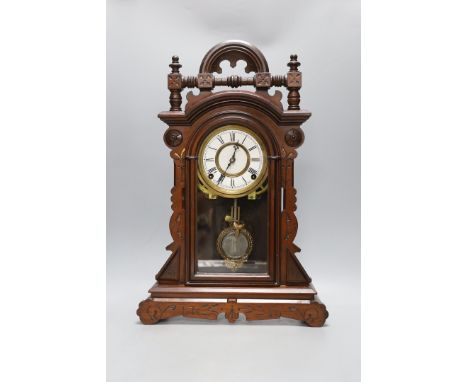 An architectural carved walnut mantel clock - 52cm tall
