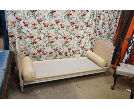 A Louis XVI style yellow painted upholstered French daybed, width 198cm, depth 69cm, height 88cm