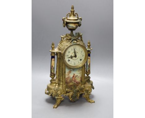 A ornamental gilt French mantel clock with painted porcelain insets - 41.5cm tall