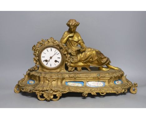A French gilt metal mantel clock with blue enamel floral decoration and mounted lady reading - 47cm long