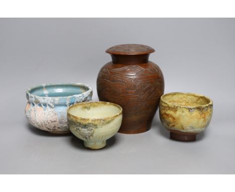 Two Japanese stoneware tea bowls (chawan), a Japanese raku bowl and a Japanese carved wood tea caddy, 19cm