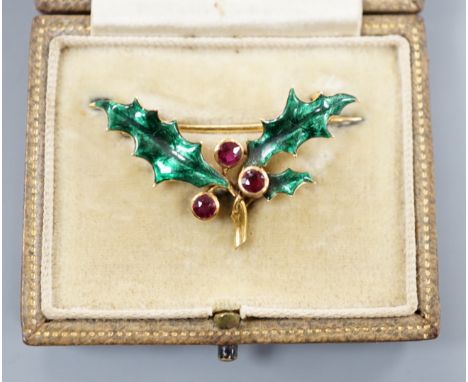 A cased yellow metal, ruby and green enamel set 'holly and berry' brooch, 36mm, gross weight 5 grams.