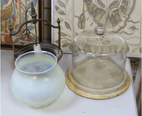 An embossed copper ceiling light with vaseline glass shade, and Far Famed Cake Co. cake stand and domed cover