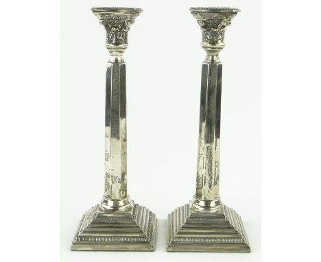 A pair of Art Deco silver candlesticks
with acanthus Capitols, octagonal columns and stepped plinths, makers marks R S, Londo
