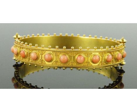 A fine quality Victorian unmarked gold and coral hinged bangle,
with applied filigree decoration and beaded edges, 16.5g tota