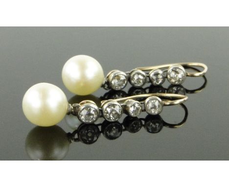Pair of pearl and diamond drop earrings,
total diamond content approx. 0.5cts, pearls approx. 7mm across, length 26mm.