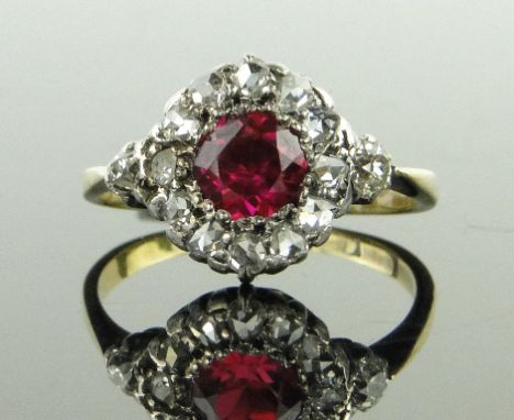 A synthetic ruby and diamond cluster ring,
unmarked gold settings, setting height 12mm, size O.