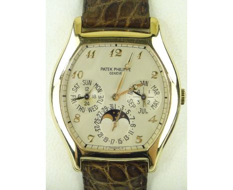 A fine Patek Philippe Grand Complications 18ct gold Tonneau wristwatch,
with perpetual calendar, day/date and moonphases with