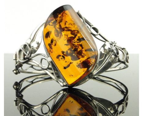 An ornate amber set silver bracelet.