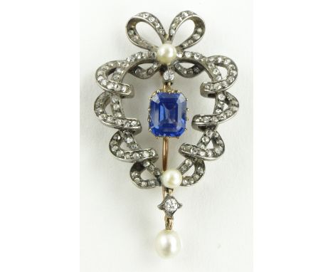 An Edwardian sapphire, diamond and pearl open work ribbon design brooch,
sapphire 7mm x 5mm, unmarked gold and silver setting