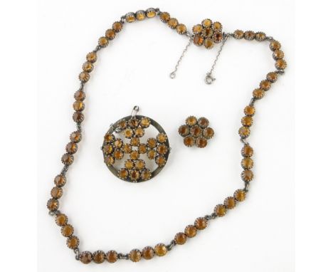 An Edwardian hessonite garnet riviere necklace,
unmarked silver settings with matching brooch and pendant, (3).