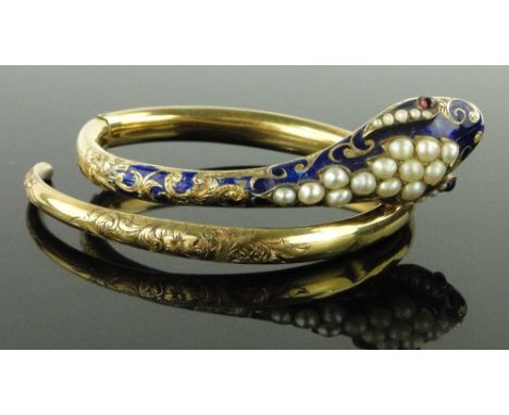 A 19th century unmarked gold sprung snake design bangle,
the blue enamel head set with pearls and ruby eyes, 19g gross.