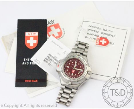 A Swiss Army compass watch, the stainless steel case enclosing claret coloured dial with luminous hands, subsidiary calendar 