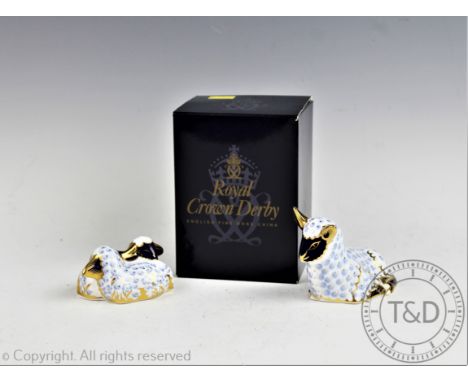 A Royal Crown Derby lamb paperweight, gold stopper, boxed, with a further paperweight of two lambs sleeping, silver stopper (