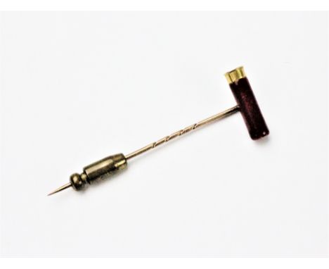 A novelty stick pin in the form of a shotgun cartridge, enamelled in red and engraved 'Eley London 410', 6.2cm long overall