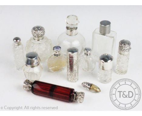 A collection of assorted silver and silver mounted scent bottles and jars, to include; a cylindrical scent bottle, Chester 19