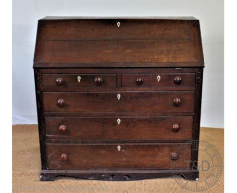 A late George III oak bureau, with fall enclosing a fitted interior, over two short and three graduated long drawers, each wi