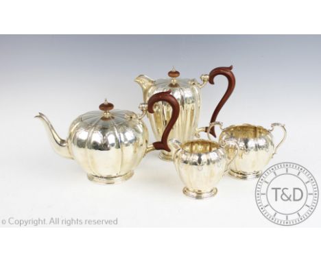 A four piece silver tea service, Elkington and Co, Birmingham 1966, each of melon shape with engraved detail and composite ha