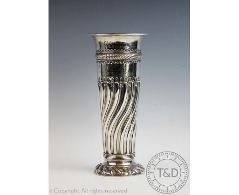 A silver vase Sibray, Hall &amp; Co Ltd, London 1894 of half wrythen form, with flared rim and spreading circular foot, engra