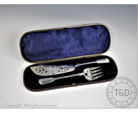 A pair of silver Victorian fish servers, H J Lias &amp; Son, London 1862, each of fiddle pattern with pierced detail and fish