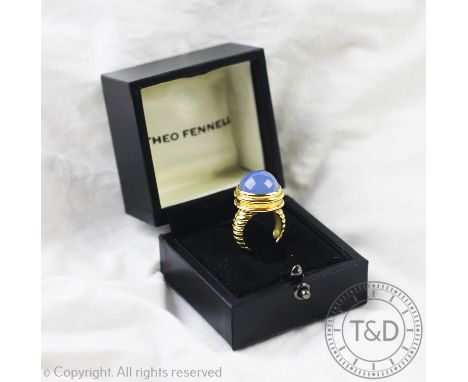 A Theo Fennell 18ct gold and blue chalcedony coloured cabochon stone set ring, the central stone within collet setting with r