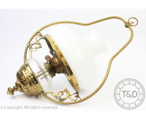 A pair of Victorian brass oil lamp wall lights, by repute from a Welsh chapel, with glass reservoirs, converted for electrici
