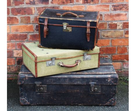 A vintage leather and canvas travelling case, 27cm H x 51cm W x 37cm D, with a larger green example and a wood bound travelli