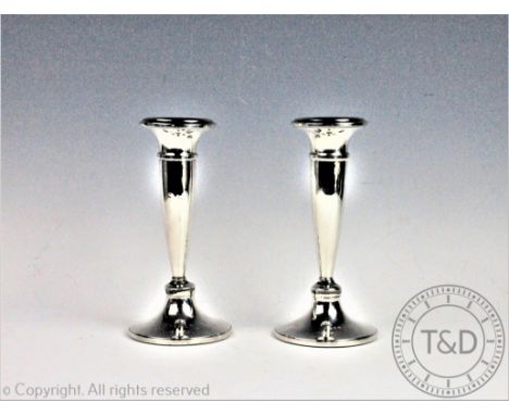 A pair of silver candlesticks, Napper and Davenport, Birmingham 1919, each of trumpet form with flared rims and spreading cir