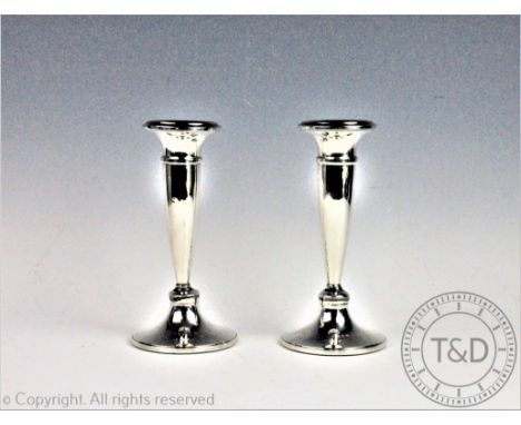 A pair of silver candlesticks, Napper and Davenport, Birmingham 1919, each of trumpet form with flared rims and spreading cir