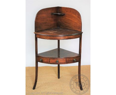 A mahogany three tier hanging shelf, with serpentine sides, 75cm H x 95cm W, with a late George III mahogany corner wash stan