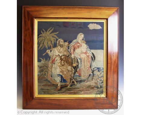 A late 19th century tapestry picture depicting Mary, Joseph and the infant Christ, in a mahogany cushion frame, 91cm x 84.5cm