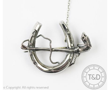 A silver hunting interest brooch, Frederick Venour, Chester 1886, designed as a horseshoe and a riding crop, 5cm wide