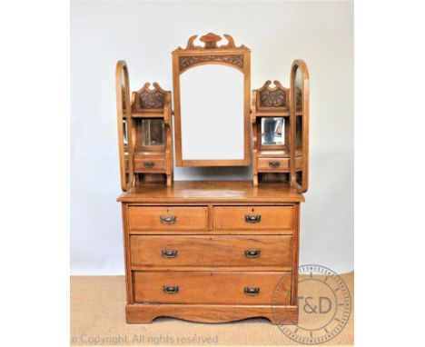 An Edwardian carved ash dressing table, with triple mirror top above  two short and three long drawers, on bracket feet, 107c