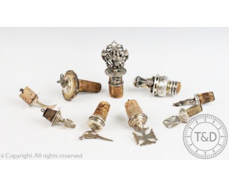 Nine assorted silver mounted bottle corks to include a pheasant example, a goat, Scotsman, three crosses etc (9)