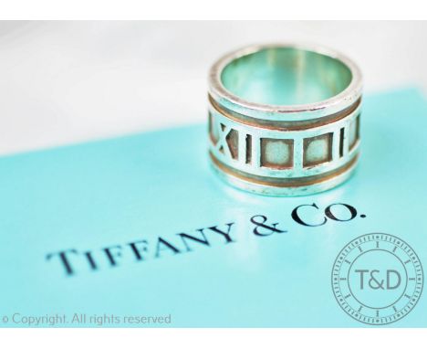 A Tiffany &amp; Co silver Atlas ring, the broad band cast with Roman numerals, stamped 'Tiffany &amp; Co 1999, 925, Italy', s