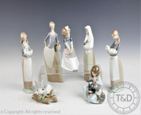 A collection of Lladro and Nao figures, to include; Lladro Girl with Cat and Dog, Girl with hands in pockets, Rabbit, Shepher