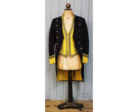 A First Footman livery uniform, comprising tail coat, waist coat and trousers, the trousers with written label 'Lonsdale 1st 