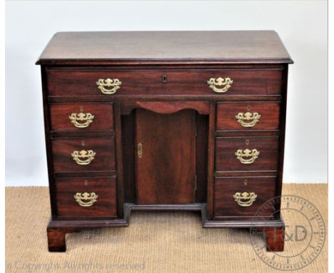 A 19th century and later mahogany kneehole desk, with one long drawer and seven short drawers around a knee hole cupboard doo