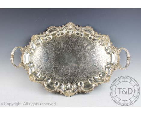 A silver two handled tray Barker Brothers, Birmingham 1901, the oval tray with shell and scroll cast rim enclosing chased scr