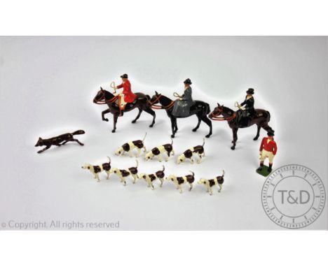 A collection Britains painted lead hunting figures comprising; huntsman on horseback, two ladies side saddle, a standing hunt