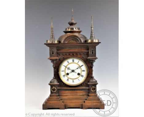 A late 19th century German carved wood mantel clock, of architectural form, with enamel Roman numeral dial and Junghans movem