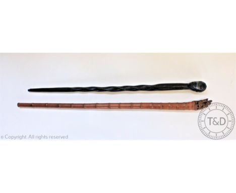 A Japanese carved bamboo walking stick, the terminal worked as a sage on a horse with female beside, 96cm, with a carved ebon