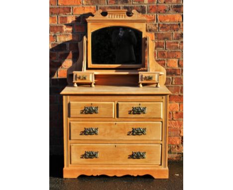 An Art Nouveau ash dressing table, with mirror top on base with two short and two long drawers, on bracket feet, with embosse